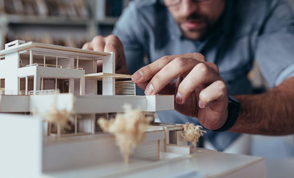 architect works on small model house