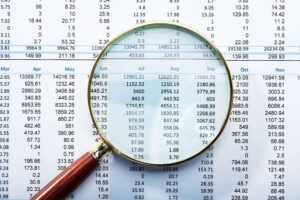 magnifying glass over financial chart